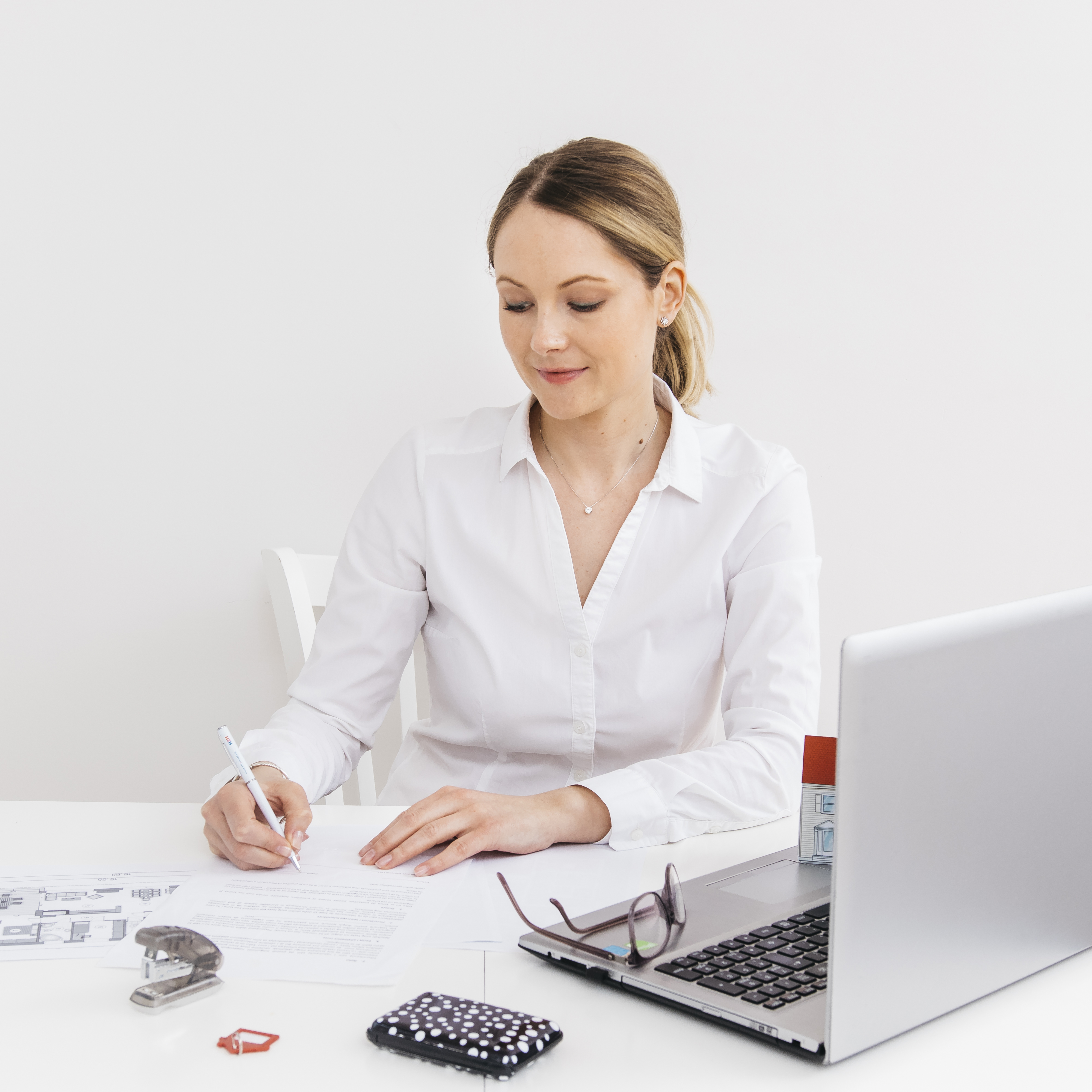 An impactful image that visually represents accounting services in Belarus, tailored to capture the professionalism of the company. The scene could depict a modern office environment with an accountant at work, surrounded by documents, a laptop, and other accounting tools, symbolizing efficiency and expertise. The background might include subtle hints of Belarusian architecture or cultural elements to establish the geographical context. The image should convey a sense of trustworthiness and modernity to align with the website's core message and attract the audience's attention.