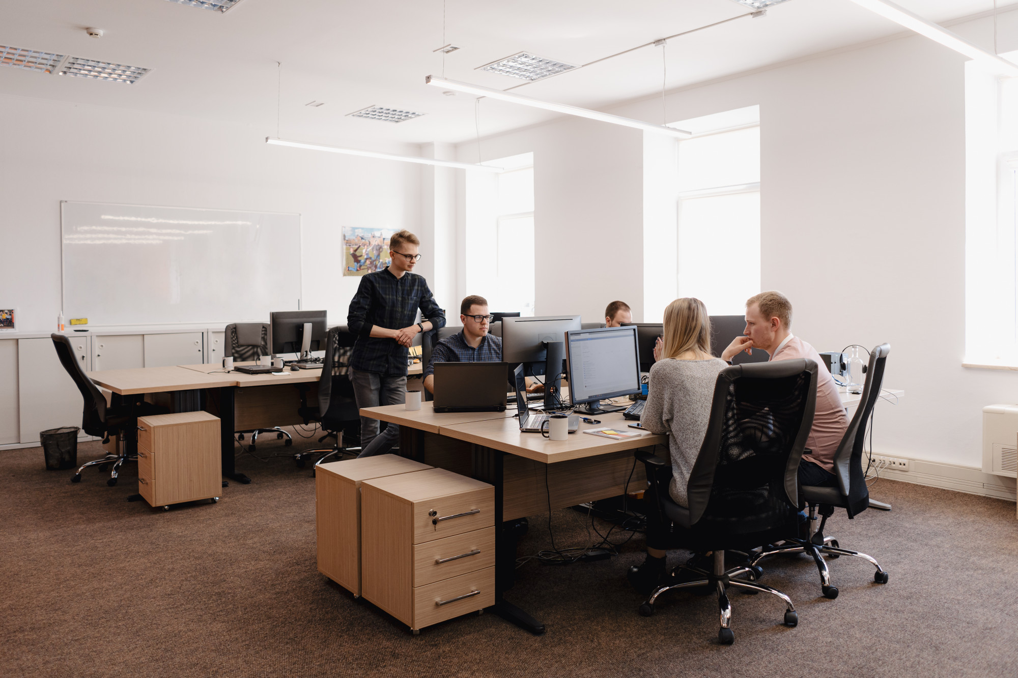 The image should depict the essence of the company, emphasizing its mission and values. It could feature elements such as a group of professional accountants engaged in a collaborative discussion, with documents and laptops indicative of their work in accounting services. The background may include symbols of growth and stability, such as graphs or buildings, to represent the company's commitment to reliability and progression in Belarus. This visual should convey a sense of trust and professionalism, aligning with the company's dedication to providing top-notch accounting services.